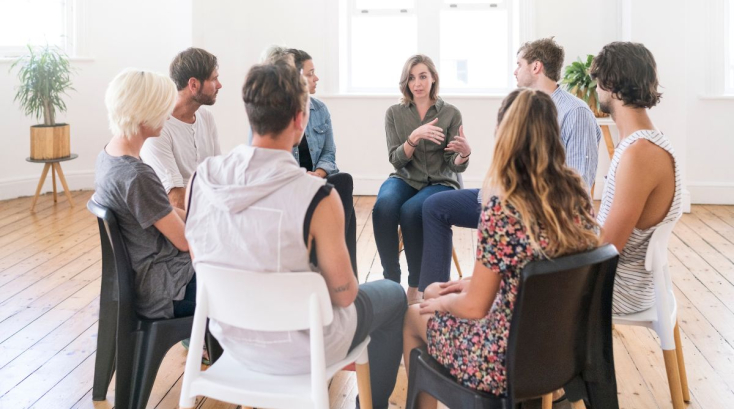 Group Of People Sitting In A Circle